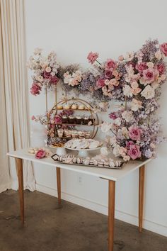 a table topped with lots of desserts and flowers