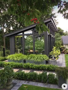 an outdoor garden with lots of plants and trees