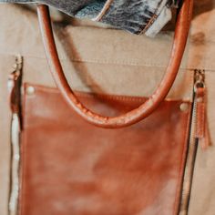 This classic tote was made to be effortlessly versatile. Bring both fashion and function to your everyday look. Color: Tan, Brown Size: 13' W x 18' H, 5" Handle Drop And Removable 24" Adjustable Strap Material: Up-Cycled Canvas, faux leather Origin: Imported Fall Hobo Bag With Adjustable Strap For On-the-go, Beige Hobo Bag With Zipper For On-the-go, Chic Hobo Bag With Zipper Pocket For Fall, Trendy Everyday Bag With Zipper Pocket, Trendy Bag With Zipper Pocket For Everyday, Leather Weekender Bag For On-the-go, Chic Satchel With Zipper Closure For On-the-go, Everyday Hobo Tote Bag With Zipper Pocket, Trendy Brown Hobo Bag With Zipper Pocket