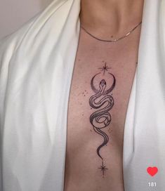 a woman's chest with a snake tattoo on her left side, and stars in the background