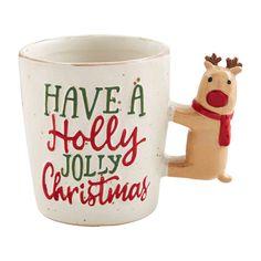 a ceramic cup with a reindeer holding it's arm and saying have a holly christmas