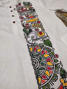 a white shirt with colorful designs on it