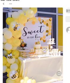 a table topped with lots of yellow balloons and honeycombs next to a sign that says sweet as can bee