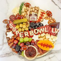 a football themed platter with cheese, crackers, fruit, and meats