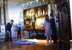 children looking at an old painting in a museum