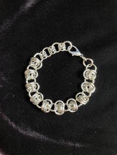 This stainless steel chainmaille bracelet is hand woven using 100% stainless steel rings. Stainless is hypoallergenic, strong, non-corrosive and very long lasting with easy maintenance.  Stainless does not tarnish or rust, making it perfect for continuous wear. It's also perfect for those with sensitivities to nickel.  This bracelet matches with our CAPHZIEL Necklace.  MEASURES  7'.5" Inches (adjustable to 9'')   19 cm (adjustable to 22.'5 cm)  THIS ITEM IS MADE TO ORDER   Expect 4-6 weeks before shipping. You will essentially be skipping the line, without having to wait for scheduled restocks that may sell out.  If you need a custom size, please include your measurements in the notes.  Handmade Disclaimer   Each piece is handmade by me. Therefore there may be slight, nearly undetectable d Silver Chainmail Stainless Steel Chain Bracelet, Silver Stainless Steel Chainmail Bracelet, Silver Chainmail Chain Link Bracelets, Silver Chainmail Bracelet With Chain Link, Silver Chainmail Bracelet As A Gift, Silver Chainmail Chain Bracelet As Gift, Silver Link Bracelet With Jump Ring, Silver Chain Bracelet With Jump Ring, Chainmail Bracelet