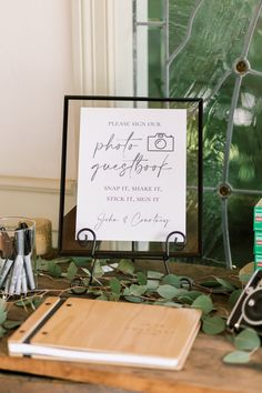 a wooden table topped with a sign and other items