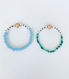 two beaded bracelets with words on them