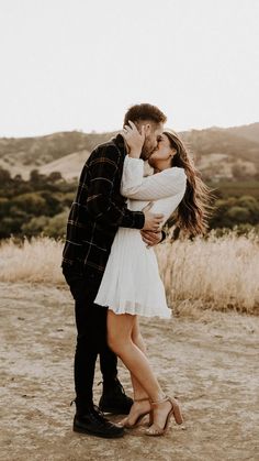 a man and woman kissing in the desert