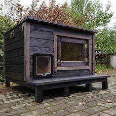 a dog house built into the side of a brick walkway