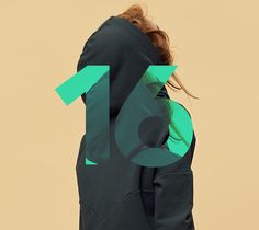 a woman wearing a green hoodie with the number thirteen printed on it's back