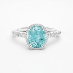 ITEM INFORMATION Gemstone:  * Paraiba Tourmaline & Diamond Paraiba Tourmaline:  * Weight: 1.50 carats * Cut: Oval Diamonds:  * Grade: G / VS-VVS Metal: * 18K White Gold * Platinum 950 Ring Dimensions: * 9x7mm (Including diamond halo) Also available in: * Different Dimensions & Gemstones * 18K Yellow Gold & 18K Rose Gold Certification: * Complimentary certificate of authenticity * Complimentary GIA or GRS certification (All our gemstones and metals are responsibly mined and traceable to their sou Luxury Tourmaline Rings With Halo Setting, Fine Jewelry Tourmaline Rings With Brilliant Cut, Gia Certified Oval Aquamarine Jewelry, Gia Certified Tourmaline Wedding Ring, Wedding Gia Certified Tourmaline Ring, Gia Certified Tourmaline Jewelry For Anniversary, White Gold Tourmaline Ring With Accent Stones, Tourmaline Jewelry With Halo Setting For Anniversary, Tourmaline Gemstones With Accent Stones For Anniversary