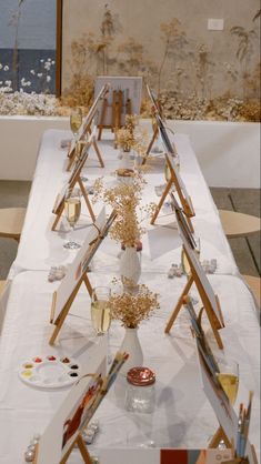 a long table covered in lots of art supplies