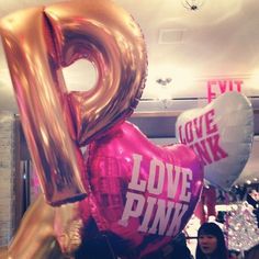 the number nine balloon is pink and gold