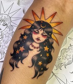 a woman's arm with a sun and stars tattoo design on the left leg