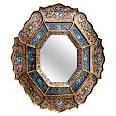 a decorative mirror with many different designs on it