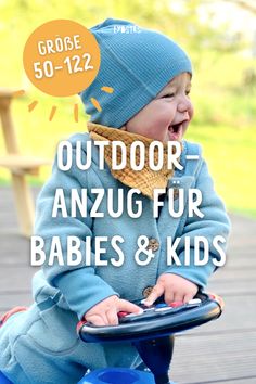 a little boy sitting on top of a blue toy car with the words outdoor anzug fur babies and kids