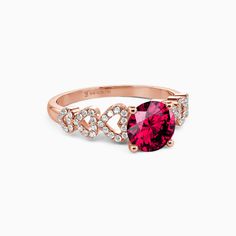 a pink ring with diamonds on the sides and a heart shaped stone in the middle