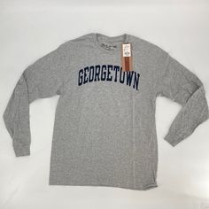 Condition: New With Tags Size: Multiple Sizes Color: Grey T-Shirt With A Navy Blue Graphic Retail: $39.98 45 Available Super Soft 90% Cotton / 10% Poly Long Sleeve Tee Shirt From The Victory. 100% Authentic Ncaa Apparel With Classic Georgetown Lettering On Chest. Perfect Basketball, Hoyas, Ncaa Basketball, Around Campus Long Sleeve T-Shirt. Athletic Heather Long Sleeve T-shirt With Letter Print, Heather Grey Long Sleeve T-shirt For Streetwear, Casual Athletic Heather T-shirt With Letter Print, Gray Text Print T-shirt For Fall, Pre-shrunk Long Sleeve Athletic Heather Top, Heather Grey Long Sleeve T-shirt With Letter Print, Long Sleeve Gray T-shirt With Text Print, Gray Long Sleeve T-shirt With Text Print, Casual Cotton T-shirt In Athletic Heather