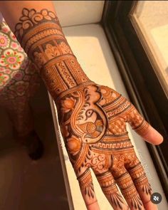 the hand is decorated with intricate designs