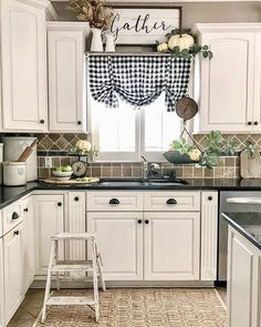 a kitchen with black and white checkered curtains on the window sill above the sink