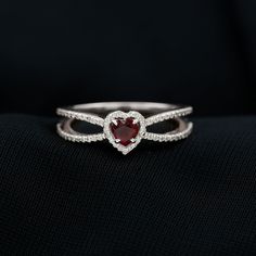 Product Details Dare to Dazzle with this sparkling Ruby Engagement Ring. This sleek Ring is embellished with alluring heart shape Ruby in the center, Diamond Accents around it and on the split shank. Product Information SKU SHP-RINGS0821219801 Width 3.7 mm Height 6.7 mm Weight 2.30 gm (Approximate) RUBY INFORMATION No.of Stones 1 Pieces Total Weight 0.47 Carat (Approximate) Dimension(approx) Heart-4X4 mm-1 Pcs Color Red Cut Brilliant Shape Heart Setting Type Accent Quality Grade AAA DIAMOND INFORMATION No.of Stones 72 Pieces Total Weight 0.29 Carat (Approximate) Dimension(approx) Round-0.80X0.80 mm-20 PcsRound-0.90X0.90 mm-52 Pcs Color HI Cut Brilliant Shape Round Setting Type Accent Quality Grade SI View More Product Parent Collection Handle ruby-engagement-rings Pave Diamond Wedding Bands, Split Shank Engagement Ring, Unique Promise Rings, Heart Engagement, Shank Engagement Ring, Split Shank Engagement Rings, Crossover Ring, Heart Engagement Rings, Ruby Engagement Ring