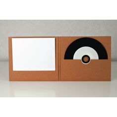 a cardboard box with a record player in the front and an empty card on top