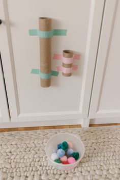 some toilet paper rolls are in a bowl on the floor