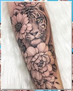 a tiger and flowers tattoo on the arm