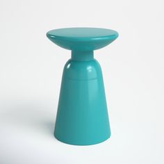 a blue stool sitting on top of a white floor