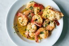 a white plate topped with shrimp and bread