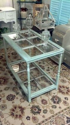 a glass coffee table sitting on top of a rug