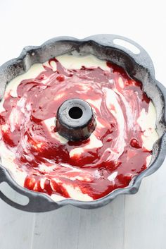 a cake pan filled with white and red icing