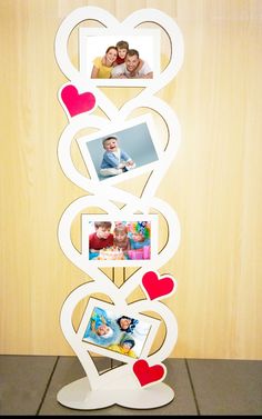 a photo frame with hearts and pictures on it