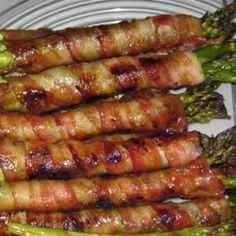 several skewered meats and broccoli on a plate