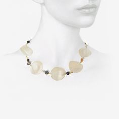 Details Gabriella Kiss 18k yellow gold & mother-of-pearl phases of the moon necklace with blue goldstone, herkimer diamonds, Ethiopian opal, labradorite, amethyst, pyrite, moonstone & 22k beads. The mother-of-pearl full moon measures approximately 1 3/8″ in diameter. The total length of the necklace is 17 1/2″ & it is finished with an 18k clasp. - custom-cut mother-of-pearl - 18k yellow gold - total length 17 1/2" Elegant Mother Of Pearl Necklace With Gemstone Beads, Unique Gemstone Necklace With Mother Of Pearl, Luxury Gemstone Pearl Necklace, Spiritual Mother Of Pearl Jewelry With Gemstones, Round Mother Of Pearl Gemstone Jewelry, Handmade Yellow Gold Mother Of Pearl Jewelry, Gold Single Strand Mother Of Pearl Jewelry, Mother Of Pearl Jewelry With Natural Stones, Round Mother Of Pearl Jewelry With Natural Stones