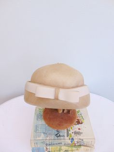 "Beautiful 60's fine weave beige dome style hat. Wide upturned brim with cream grosgrain ribbon trim. Made in England for \"Alexander's\". Measurements: 21\" Circumference inside 6\" height to top of button 29\" circumference outside brim Brand/Maker: Made in England for Alexander's Condition: Excellent! *Please feel free to message me with any additional questions * { Instagram. Hamptonsvintagemarket } { Facebook. @HamptonsVintageMarket }" Beige Cloche Hat For Church, Vintage Cream Mini Hat For Formal Occasions, Vintage Cream Mini Hat For Formal Events, Beige Vintage Formal Mini Hats, Formal Vintage Beige Mini Hat, Cream Cloche Hat With Short Brim For Church, Vintage Cream Mini Hats With Curved Brim, Vintage Cream Mini Hat With Curved Brim, Vintage Cream Mini Hat For Church