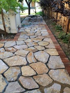 a stone path in the middle of a yard