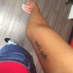 a person with a tattoo on their arm that reads, stay strong and hold onto the leg