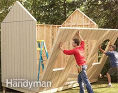 two men are building a shed in the yard