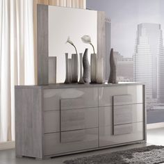 a modern dresser with vases on it in front of a cityscape background