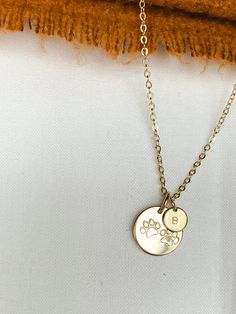 14k Gold Filled and Sterling Silver Paw Print necklace. Dainty, minimalist jewelry that can be layered with multiple necklace styles and lengths.  Show your love for your favorite fur baby today, or gift to a pet loving friend! Personalize any letter, or numbers of your choice. Handmade with 14k Gold Filled or 925 Sterling Silver metal.  Please note that jewelry color may vary slightly from image due to computer quality.  Also, please note that each item is handmade, thus letter placement may vary slightly which makes each piece uniquely designed for you! DETAILS: 13mm gold filled or sterling silver pendant  6mm Gold filled or sterling silver necklace chain and clasp 1.5 initial stamped design Each purchase comes ready for gifting! Also, I try very diligently to have each order shipped ASA Multiple Necklace, Paw Jewelry, Necklace Styles, Paw Necklace, Pet Jewelry, Stamped Necklaces, Paw Print Necklace, Dog Necklace, Baby Jewelry