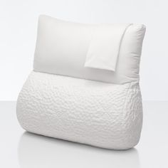 a white bed pillow with two pillows on it and one is folded up to the side