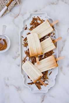 three popsicles sitting on top of a white plate