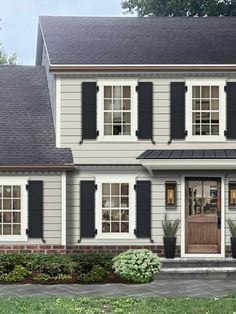 a two story house with black shutters and white trim