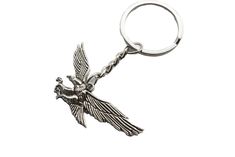 a metal keychain with a bird on it's back and two hands