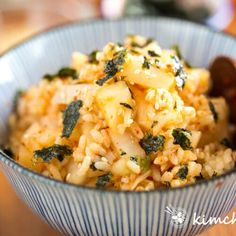 a bowl filled with rice and vegetables on top of a table