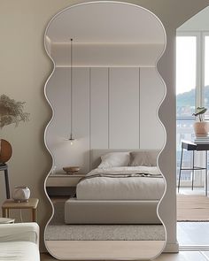 a bedroom with a large mirror on the wall above it's headboard and bed