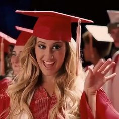 a woman wearing a red graduation cap and gown