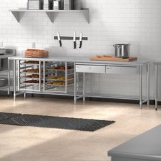 a kitchen with stainless steel counters and shelves